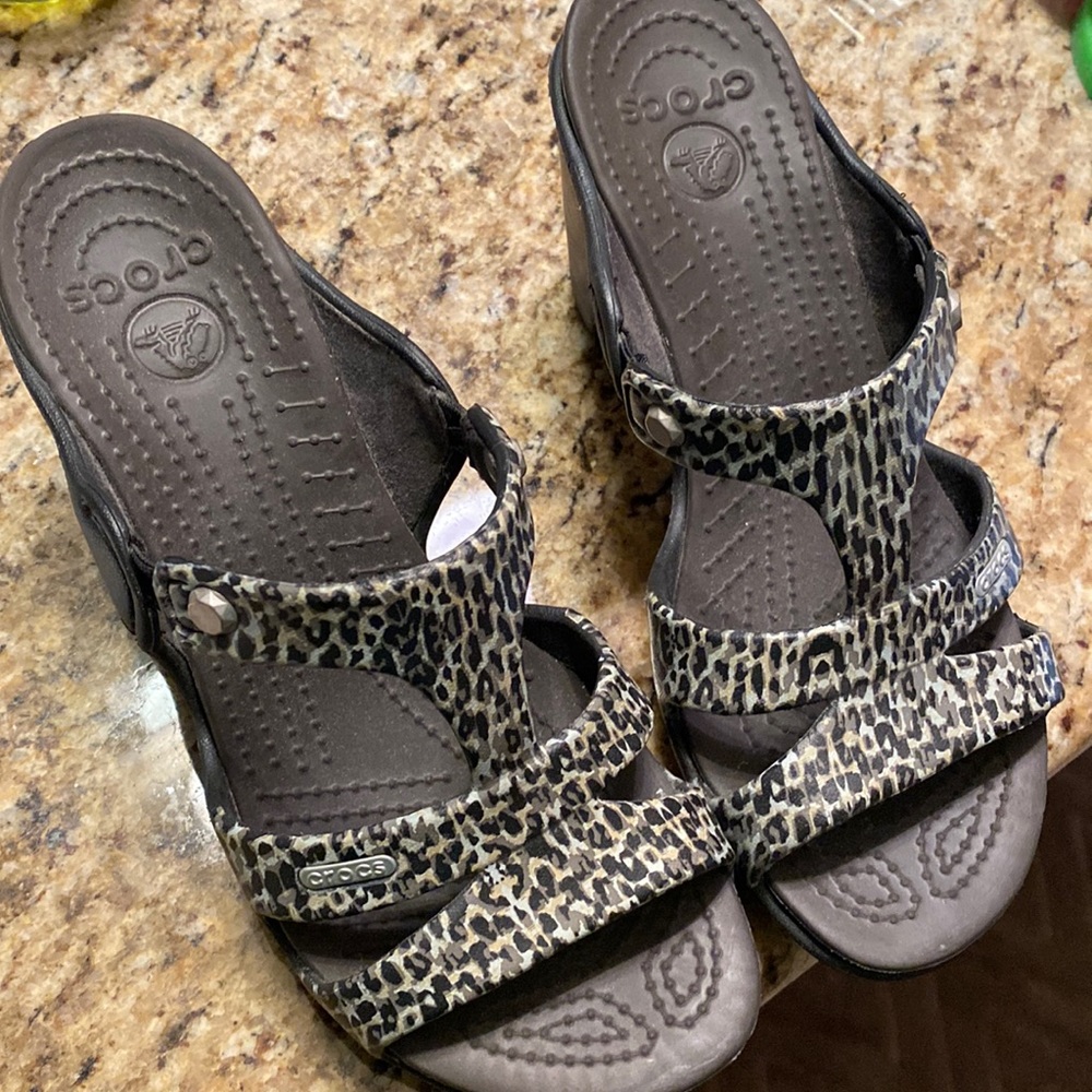 Platform heeled crocs.